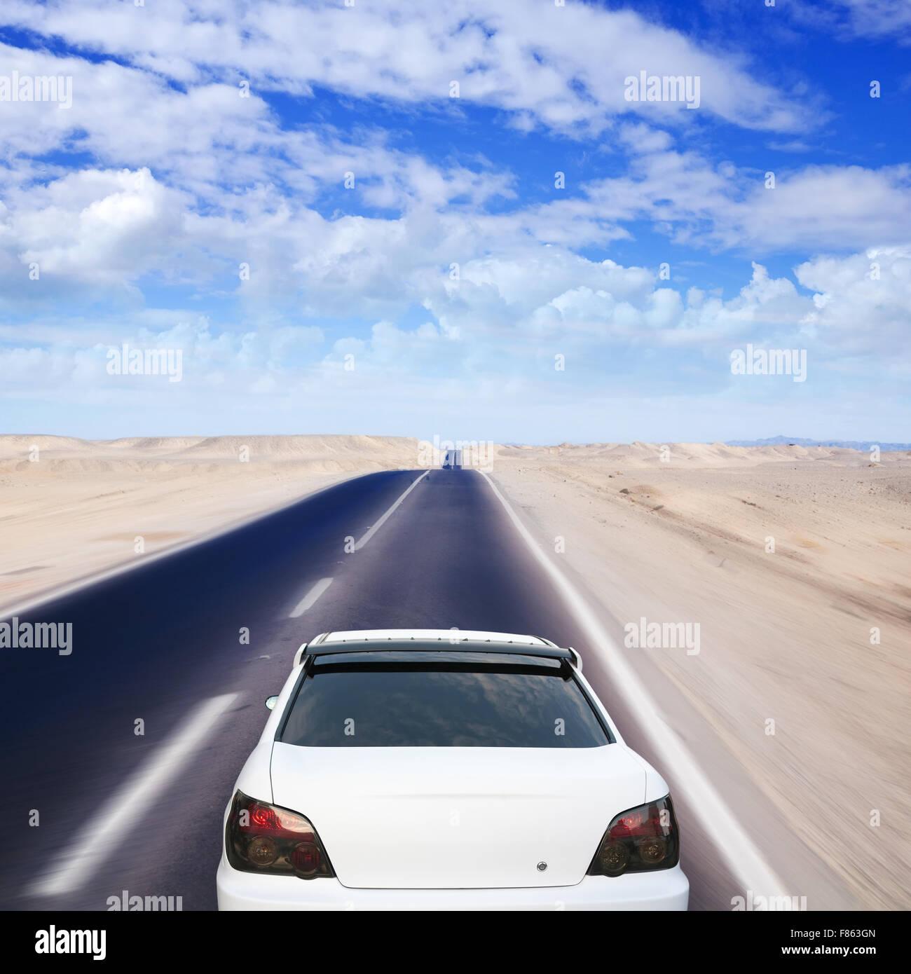 White car on desert road under blue sky Stock Photo - Alamy