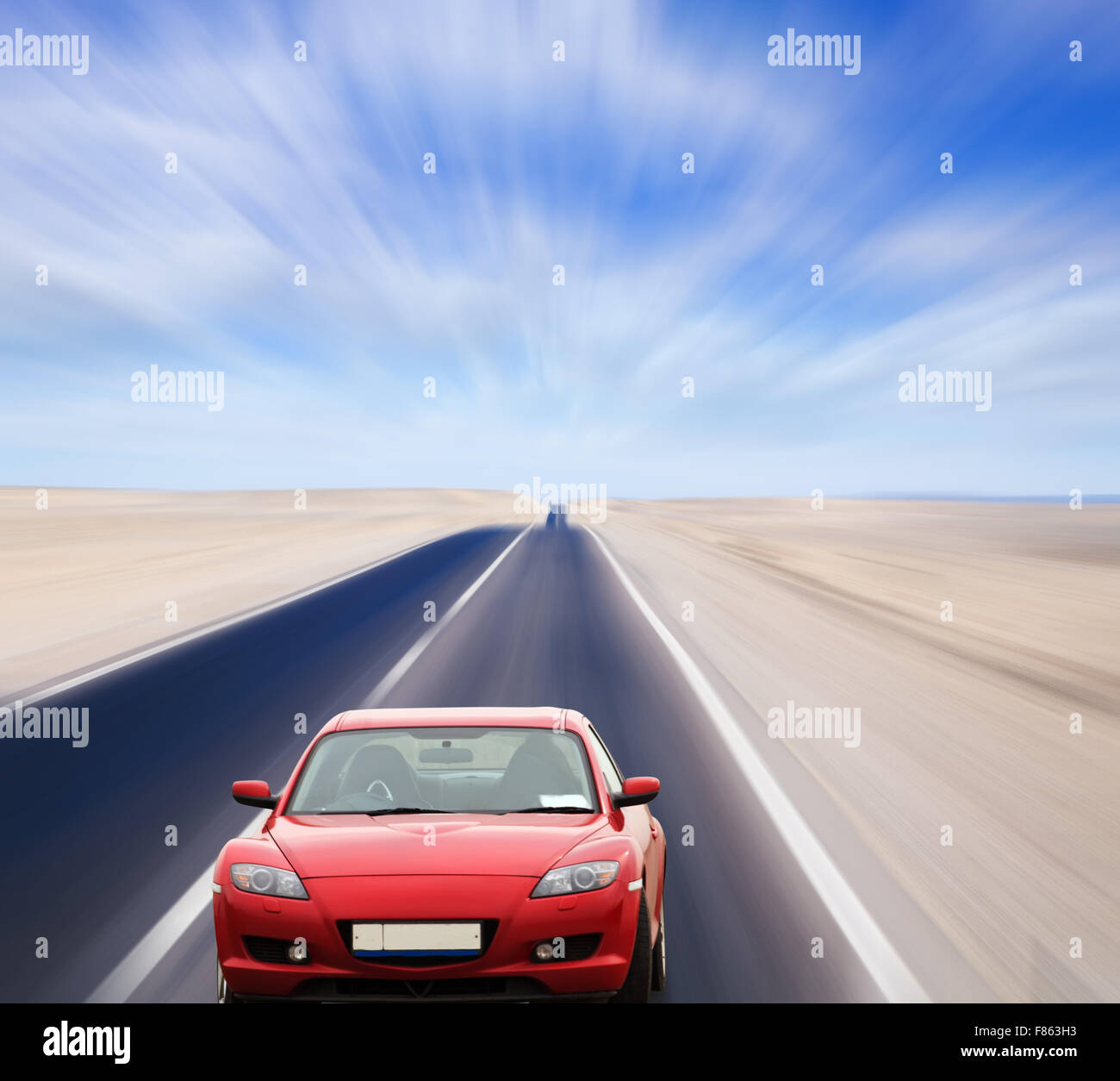 Red car on desert road under blue sky Stock Photo - Alamy