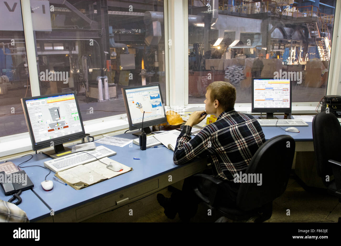 Worker in factory control room Stock Photo