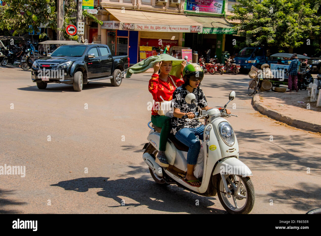 Two girls on motor scooter in Siem Reap Cambodia Stock Photo
