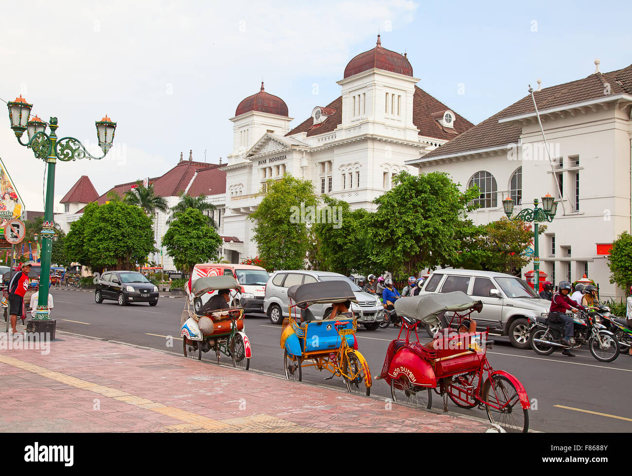 Java Streets YOGYAKARTA - AUGUST 03: Traditional rikshaw transport on streets of ...