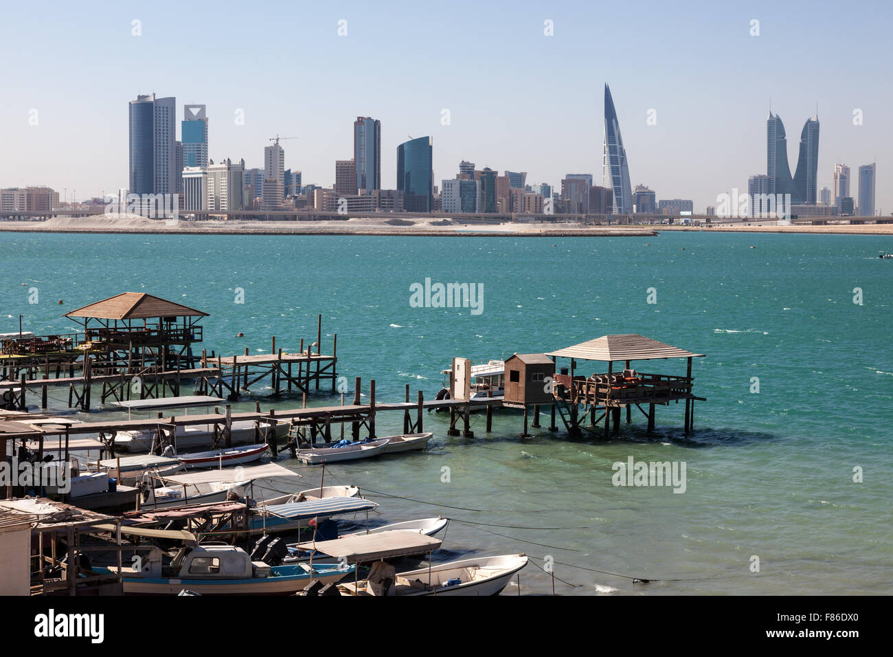 Fishing boats and the skyline of Manama, Bahrain Stock Photo