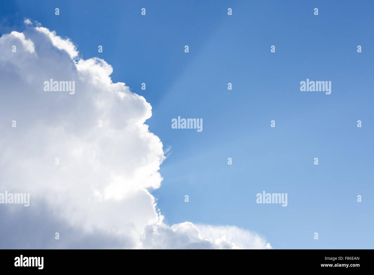 Sun rays shining behind cloud in the sky Stock Photo - Alamy