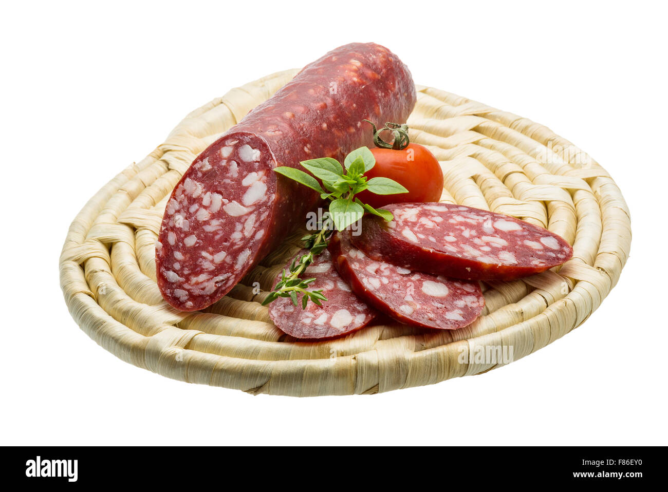 Salami sausages sliced with basil and tomato Stock Photo - Alamy