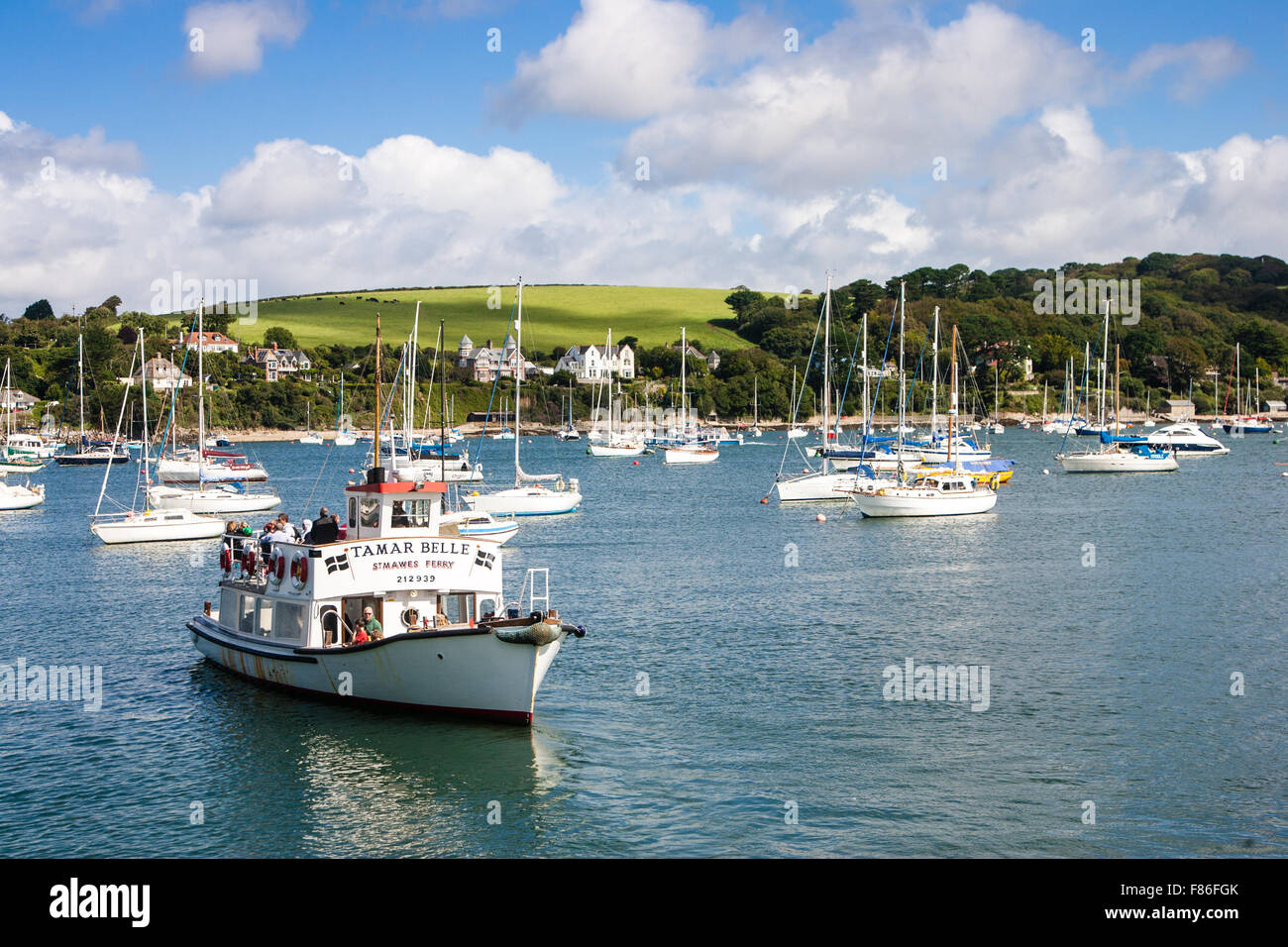 Fowey ferry cruising in front of moored boats Stock Photo
