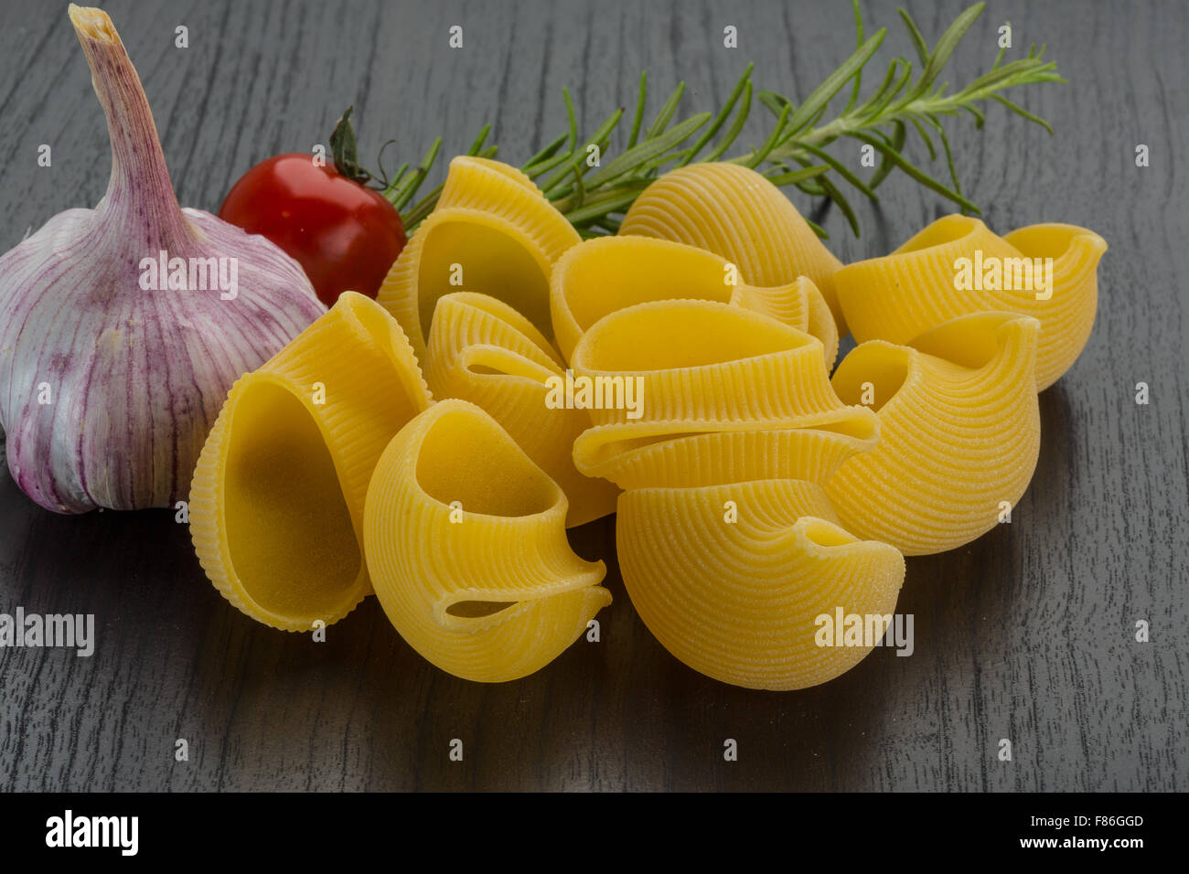 Raw shell pasta with herbs Stock Photo - Alamy
