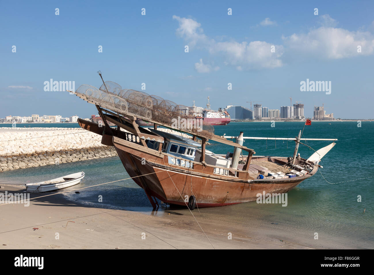 Traditional fishing dhow in the beach in Bahrain, Middle East Stock Photo