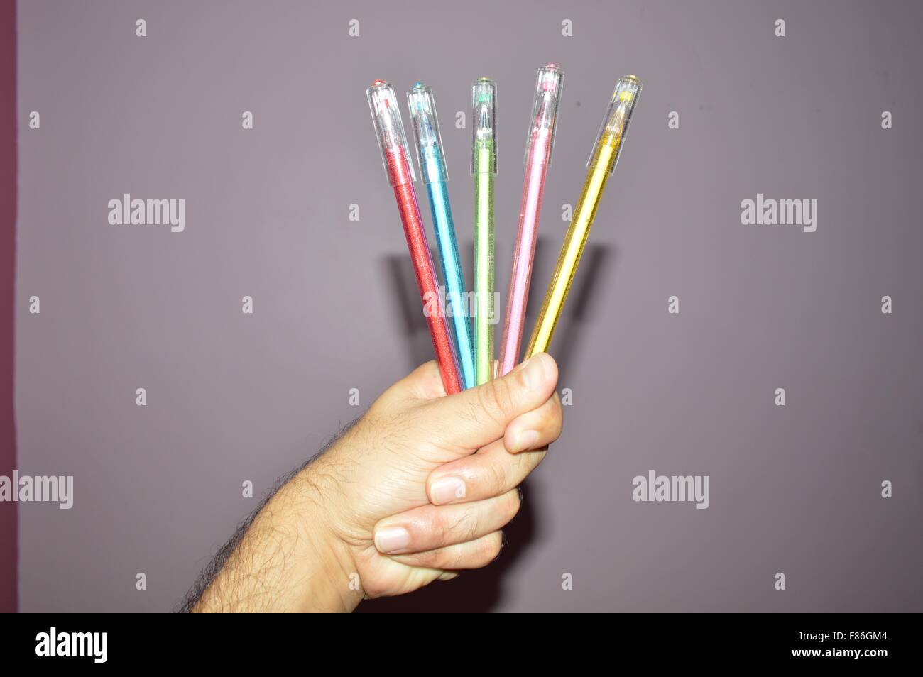Multicolor pen set and white-board marker pen in  human hand Stock Photo