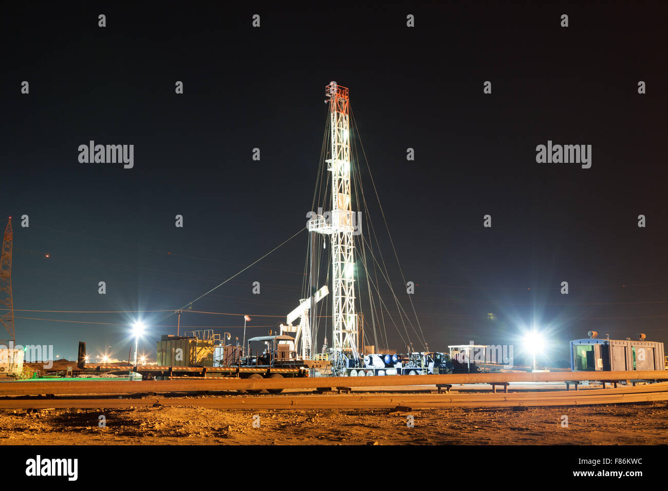 Oil drill machinery bright illuminated at night Stock Photo