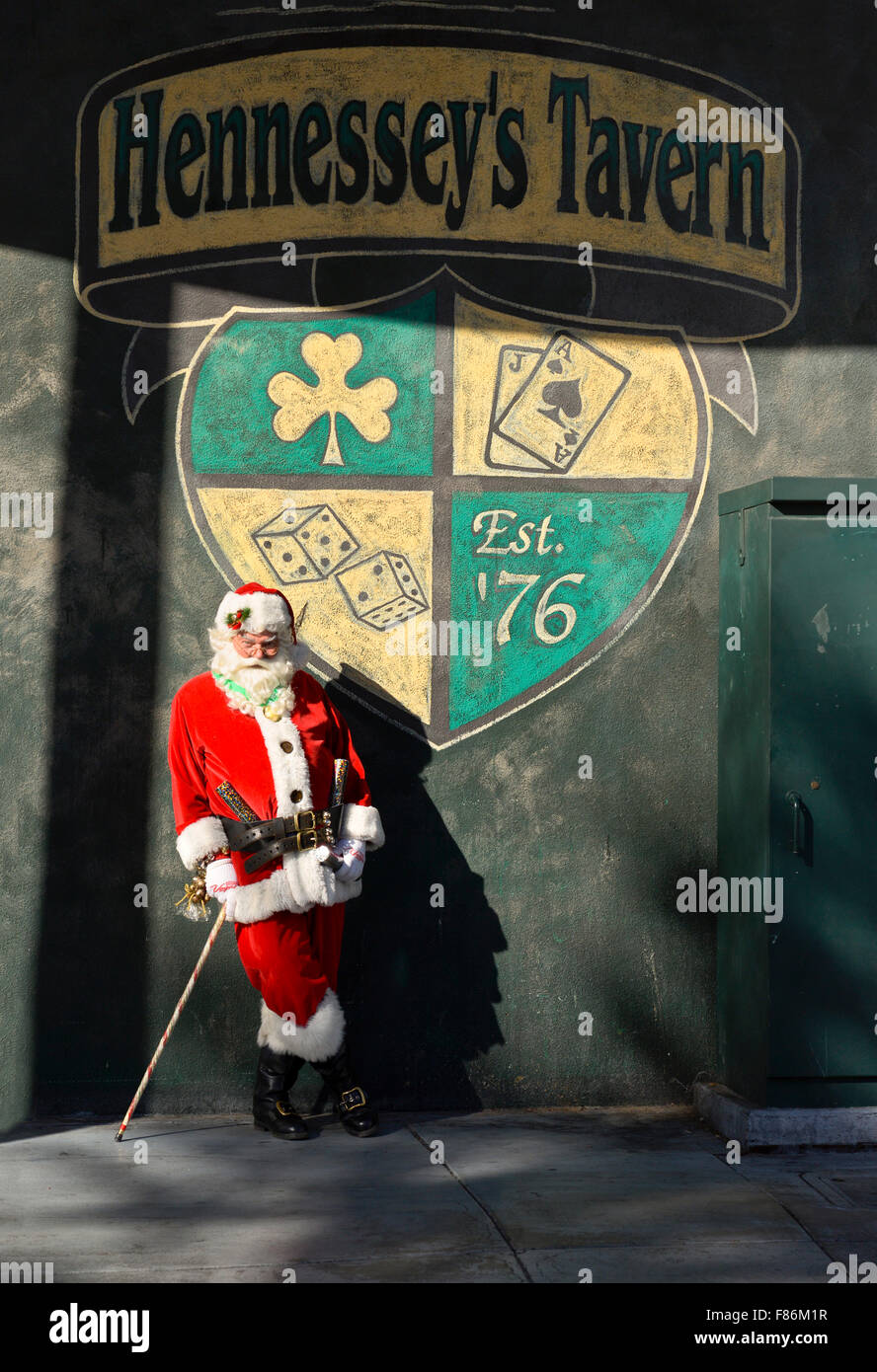 Las Vegas, US. 05th Dec, 2015. A man dressed in an authentic Santa Claus outfit poses for picture at the Great Santa Run in front of the Hennessey's Tavern Sign in the Fremont District, Las Vega Credit: © Ken Howard/Alamy Live News  Stock Photo