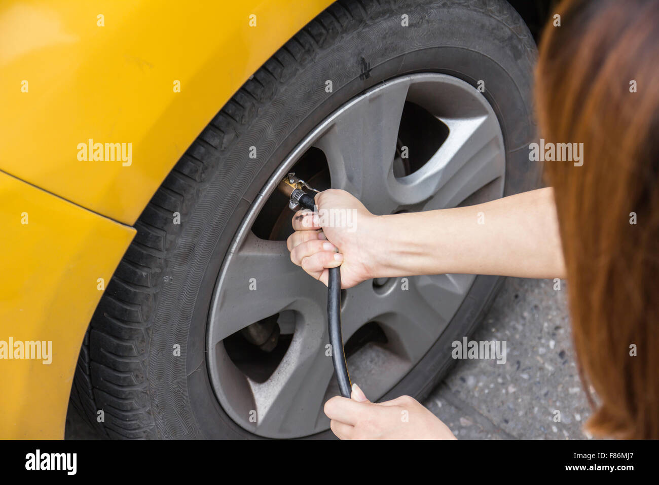 Hand filling air into a car tire, close up Stock Photo Alamy