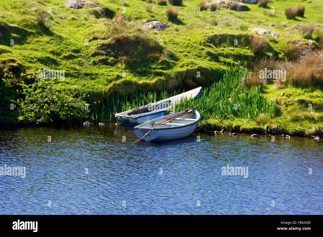 2 rowing boats moored in remote location on Harris Stock Photo - Alamy