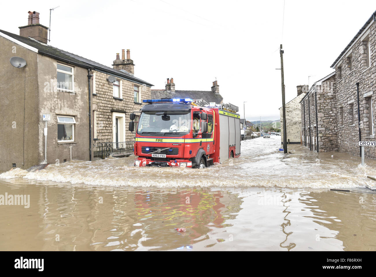 Kendal, UK. 06th Dec, 2015. A fire engine drives through flood water in Kendal after Storm Desmond wreaked havoc in the county of Cumbria. Storm Desmond caused  severe flooding in Kendal and across Cumbria. Credit:  Michael Scott/Alamy Live News Stock Photo