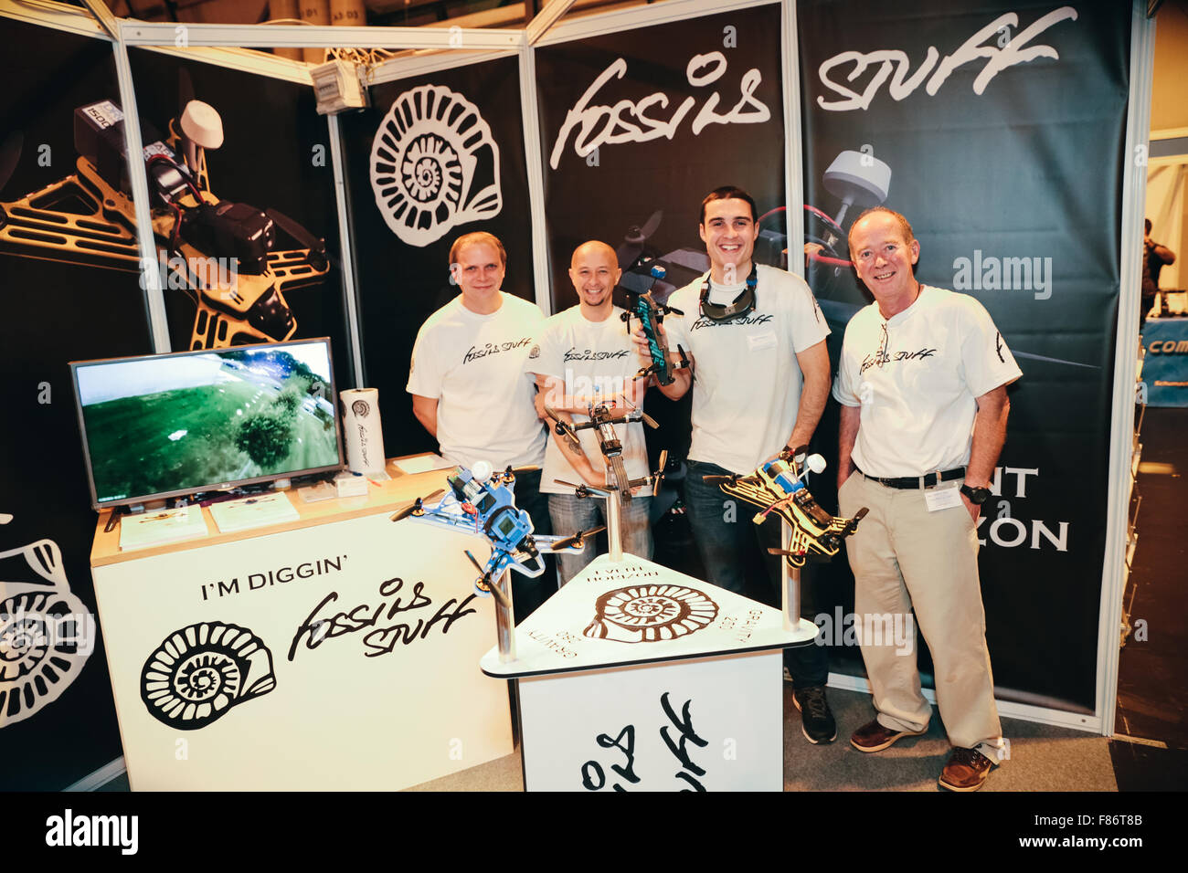 Birmingham, UK. 05th Dec, 2015. The UK Drone Show consumer drone fair, NEC conference centre, Birmingham, UK #ukdroneshow.  Pictured - Fossils Stuff's FPV (first person view) drone racing team pilots (l-r) Chris Weston, Jonny Banton and Tony  Marchant, with (r) Martin Rye, owner of Fossils Stuff.  Jonny is holding the new, as yet unreleased racing frame,  the 'Event Horizon'. © David Stock/Alamy Live News Credit:  David Stock/Alamy Live News Stock Photo