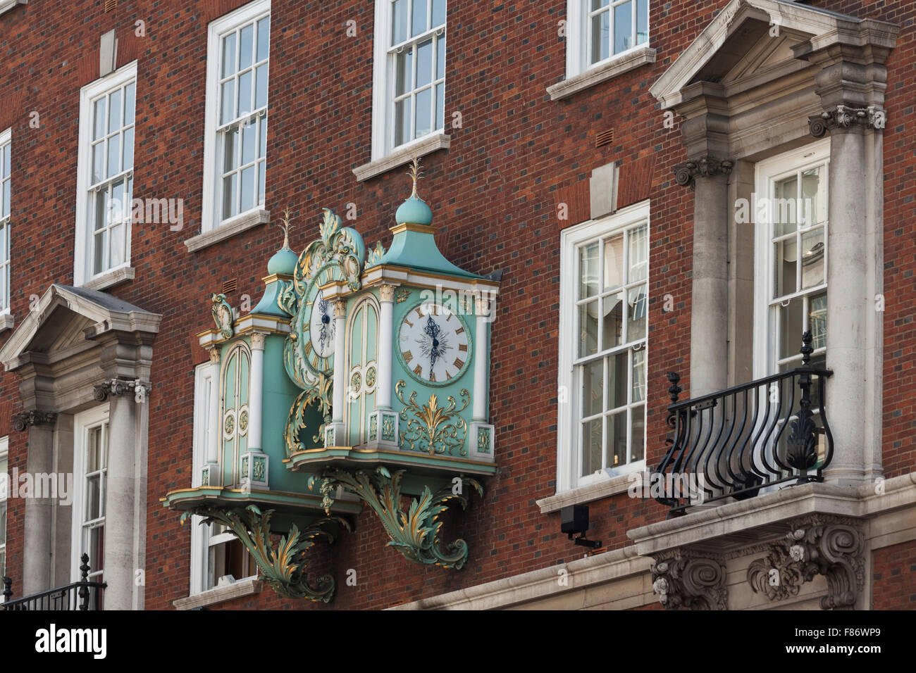 Artistic old clocks on the wall of London building Stock Photo Alamy