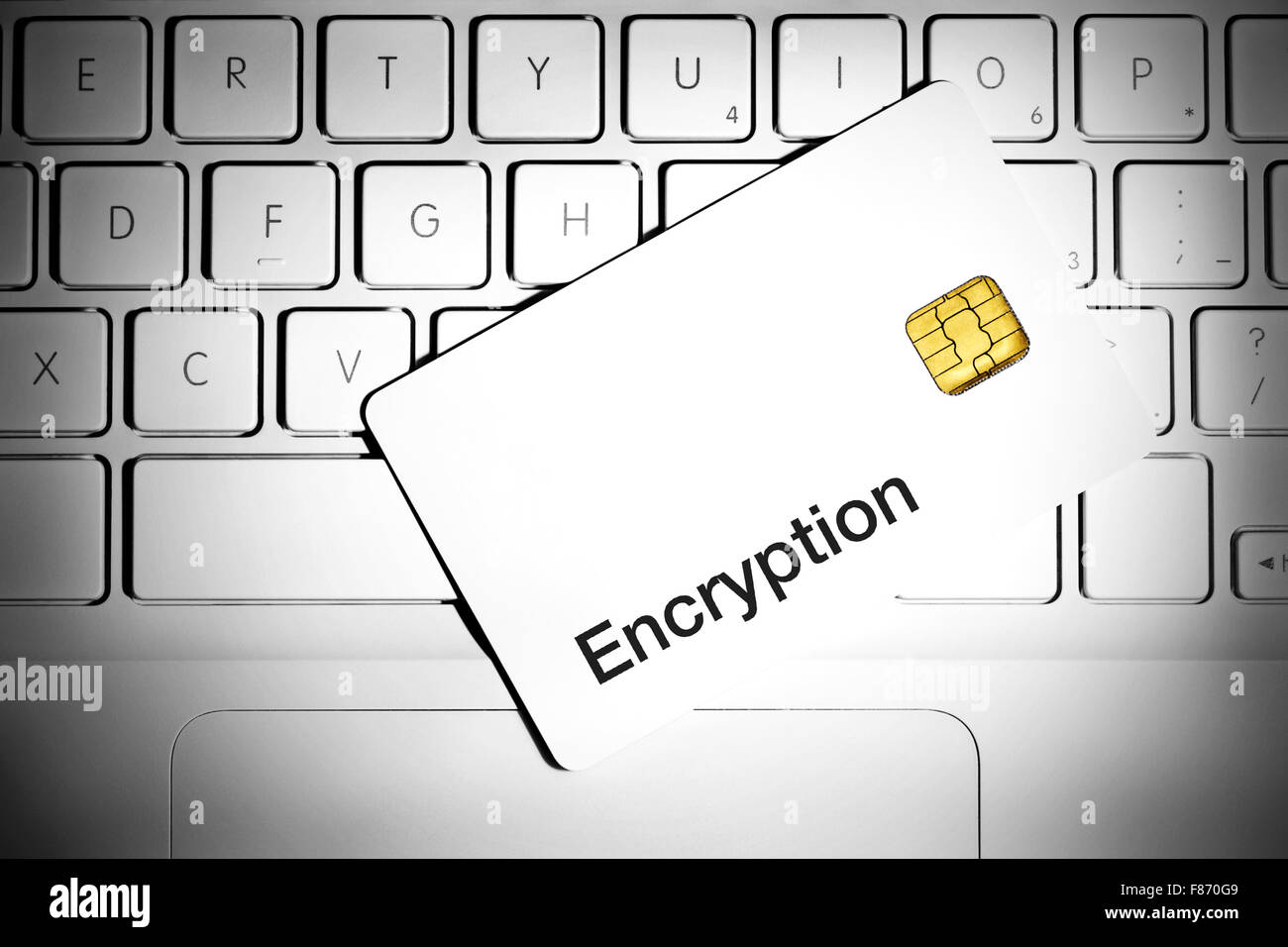 Data Encryption Concept. Smart card on a keyboard of white laptop computer Stock Photo