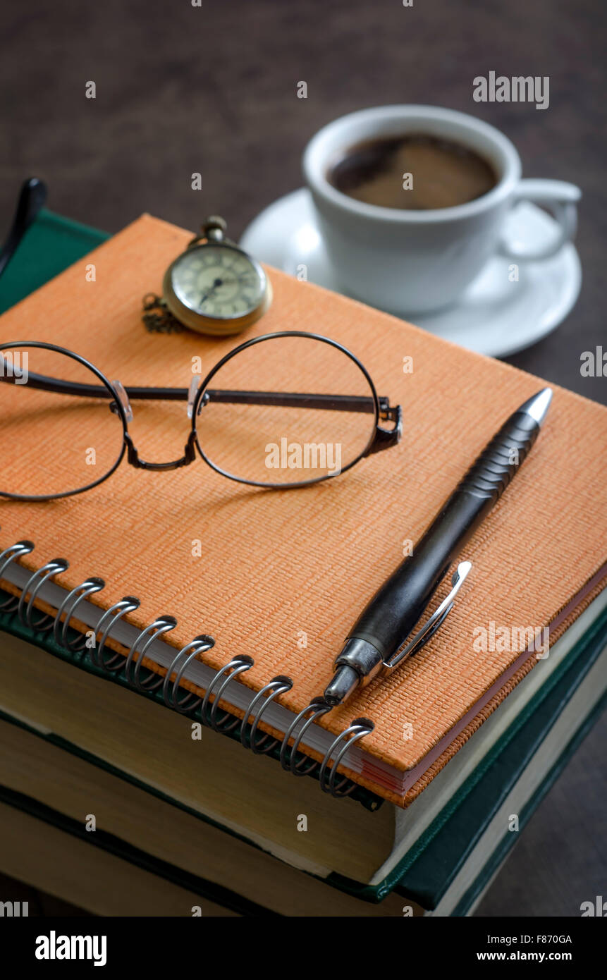 Stack of books and a pair of glasses on top of it. Close up Stock Photo
