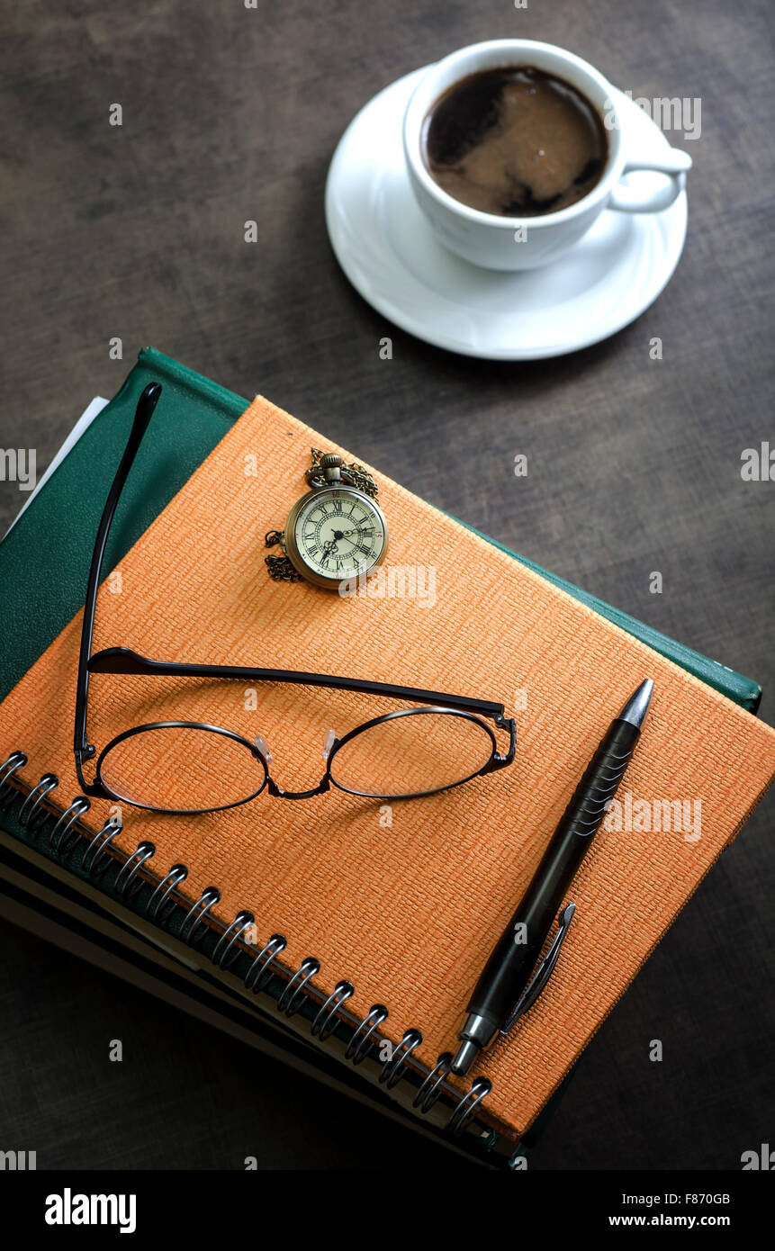 Stack of books and a pair of glasses on top of it. Close up Stock Photo
