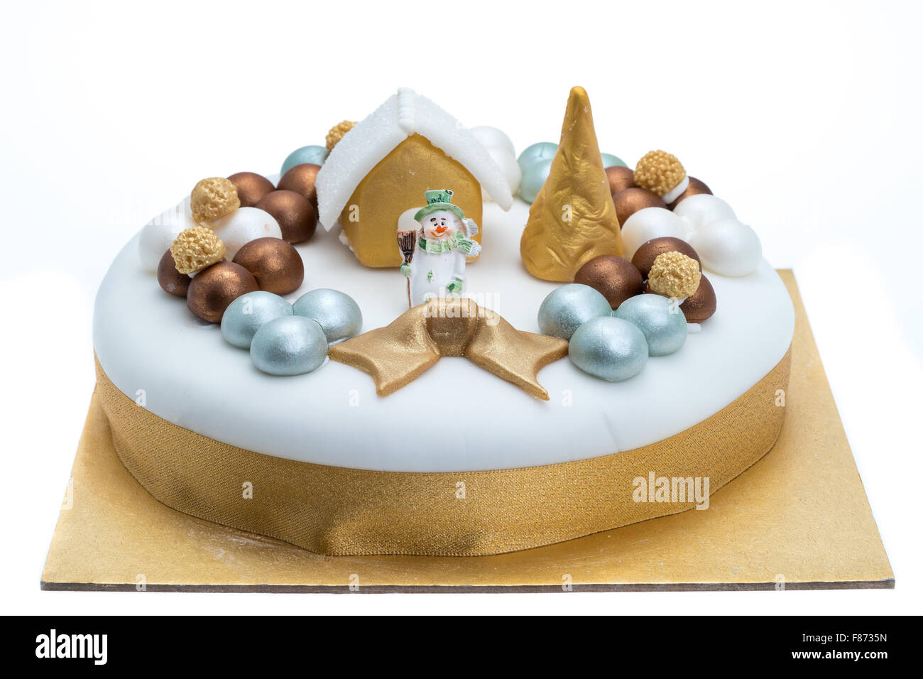 Christmas cake that has been decorated with Festive ornaments - studio shot with a white background Stock Photo