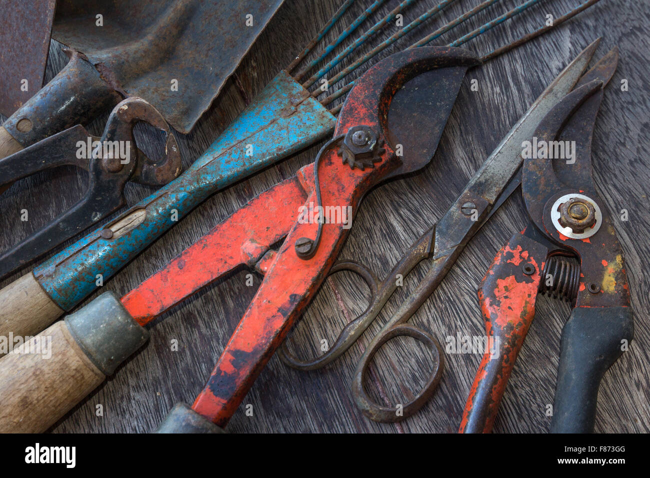 Old rusty tools - dirty tools - vintage garden tools on wooden background Stock Photo