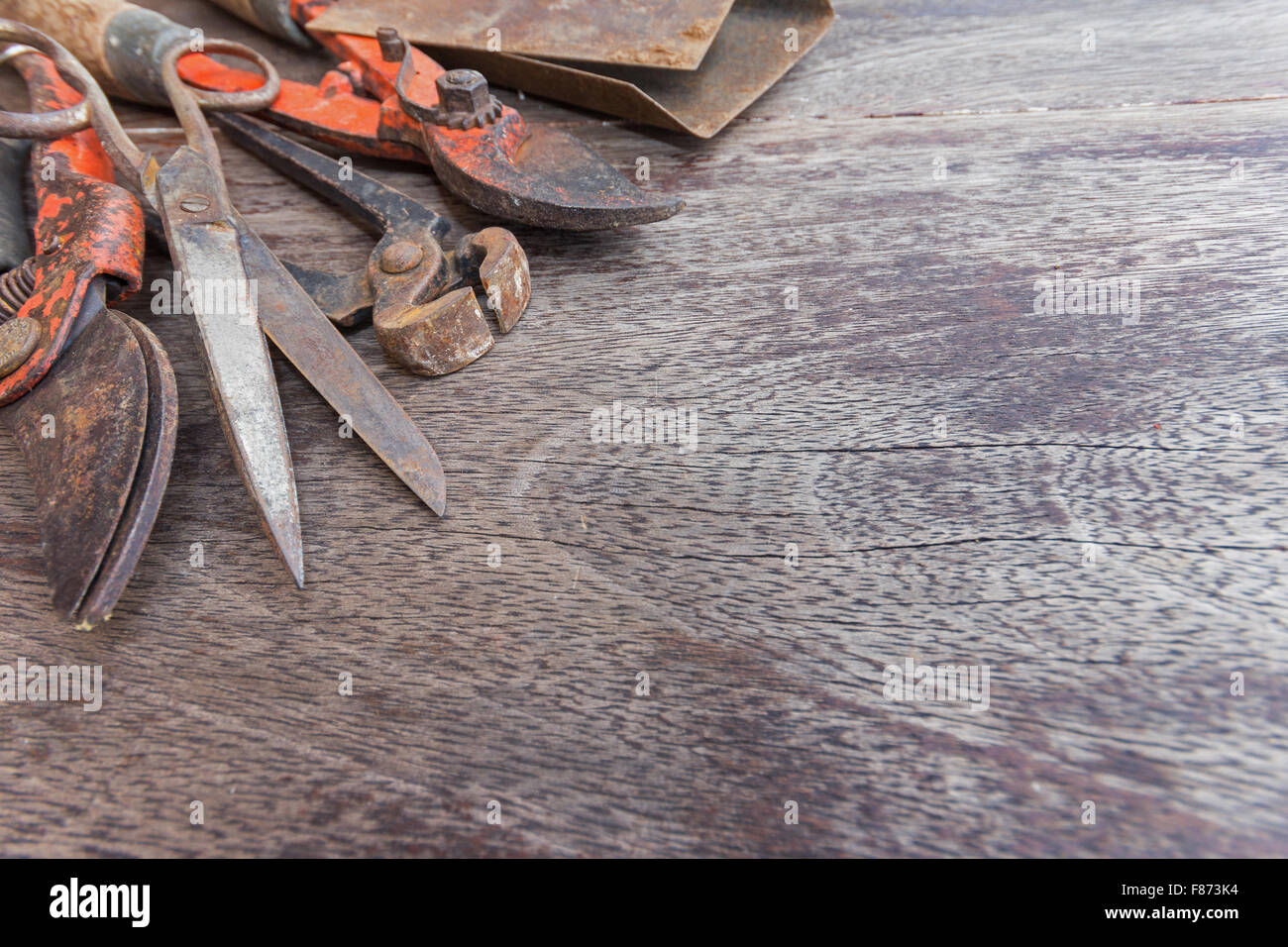 Old rusty tools - vintage handicraft tools on wooden background with copy space Stock Photo