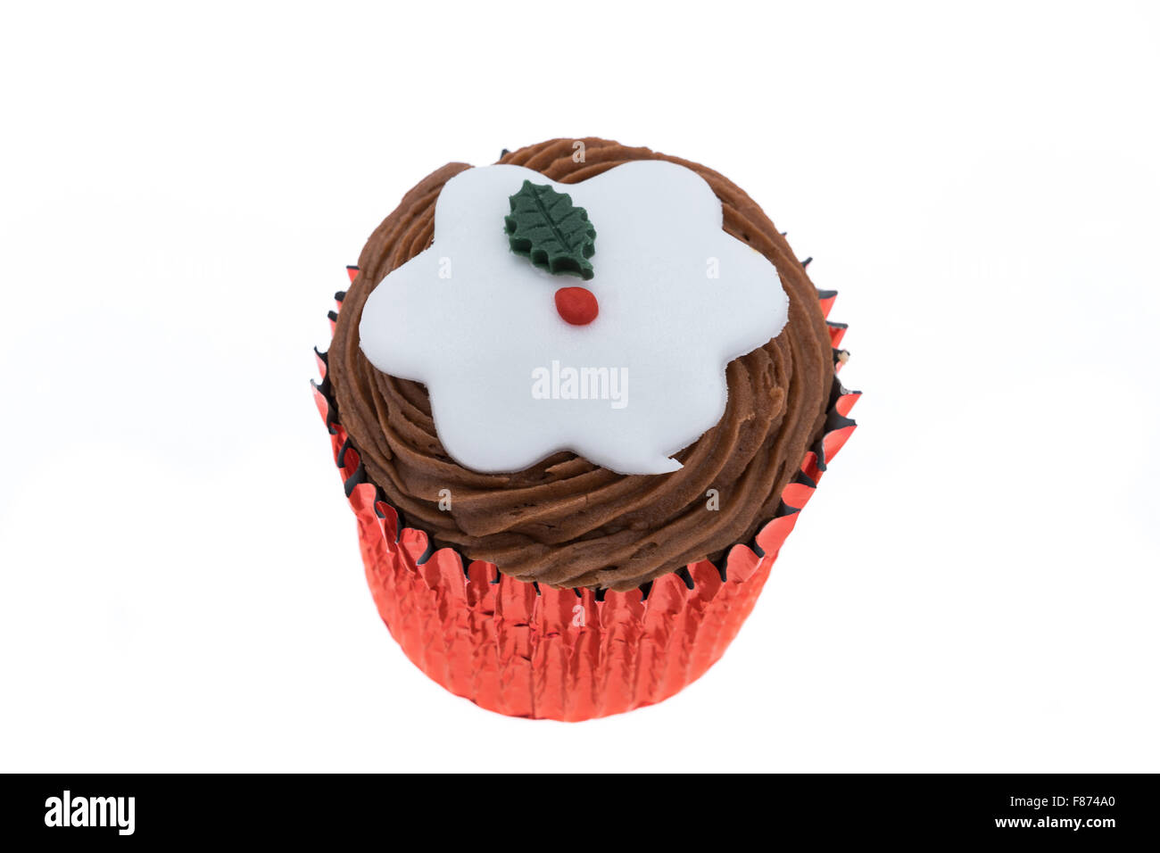 Cupcake with a decorated Christmas design of a Christmas pudding - studio shot with a white background Stock Photo