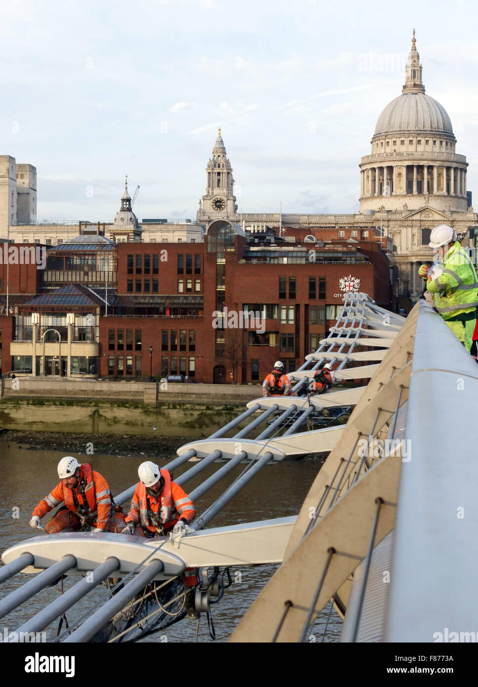 Workmen painting the Millennium Bridge, London Stock Photo