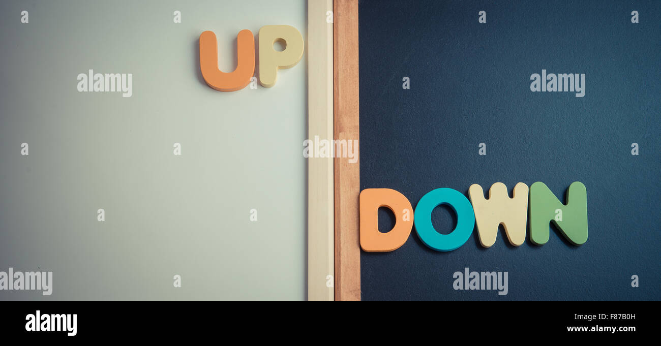 Wooden word UP and DOWN on black board and white board in Vintage style ...