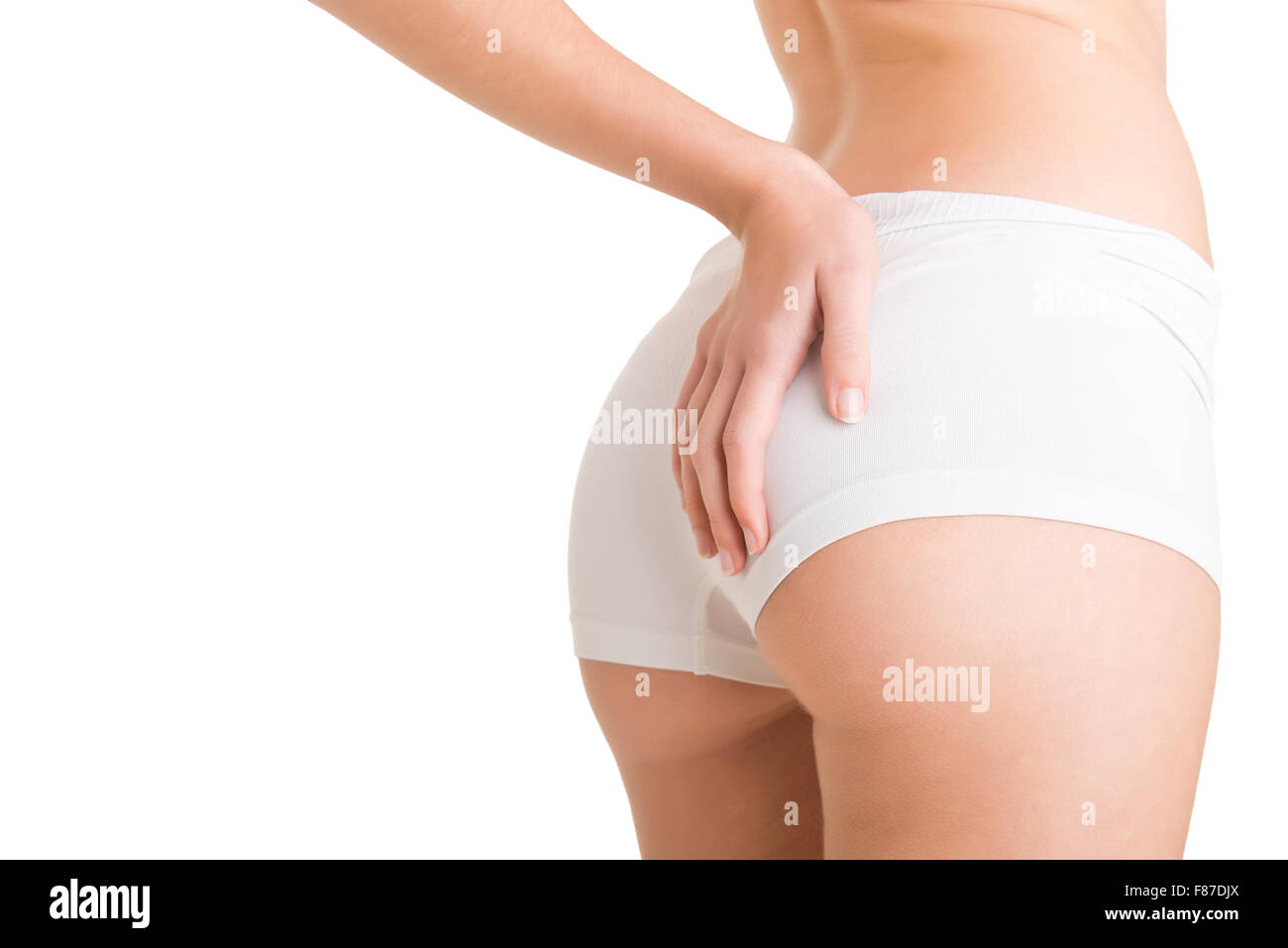 Closeup of woman examining her buttocks looking dor cellulite, isolated in white Stock Photo