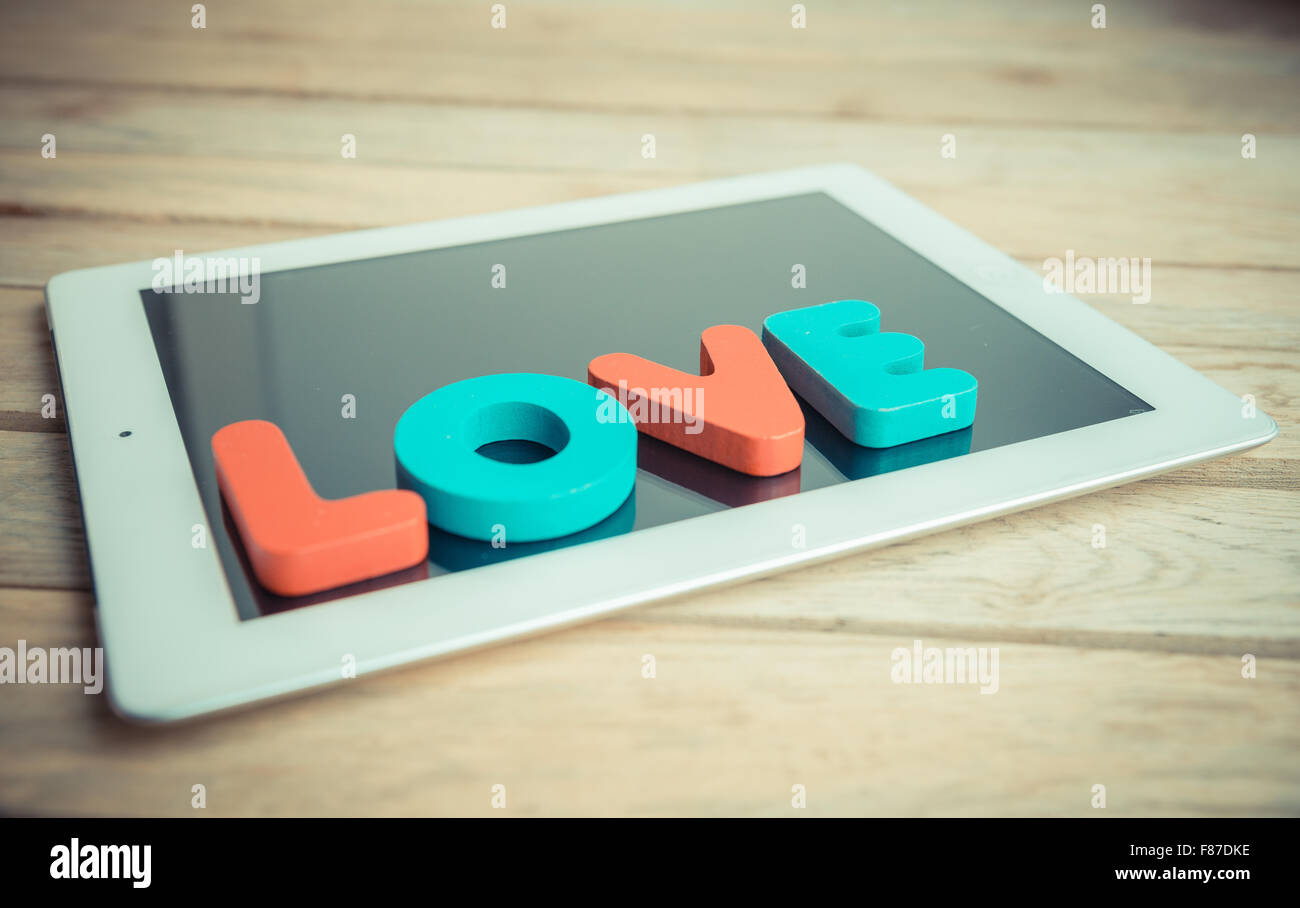 Wooden word LOVE on tablet in vintage style Stock Photo