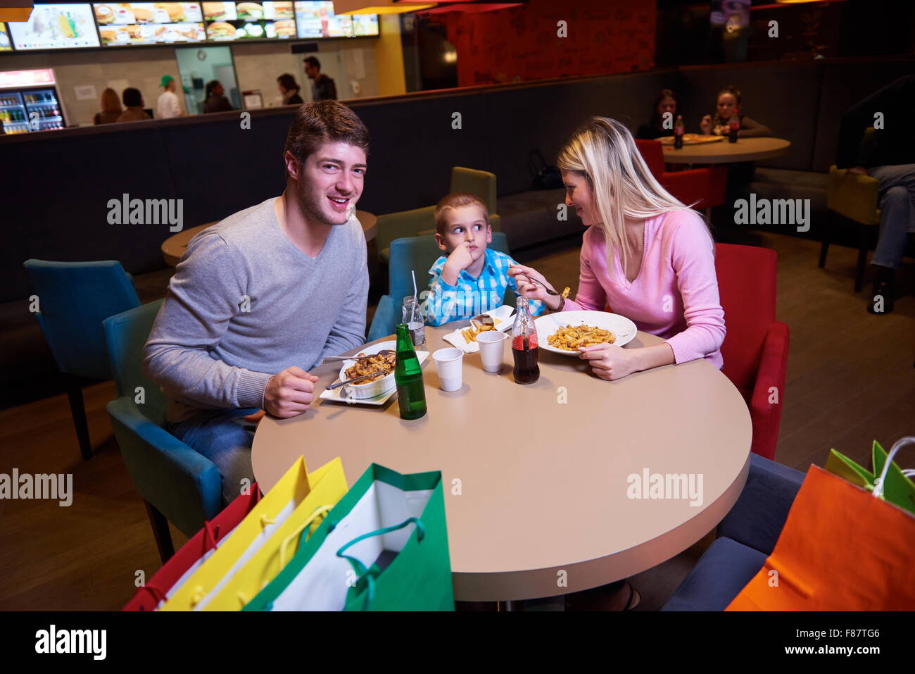 family together have break at lunch in shopping mall Stock Photo