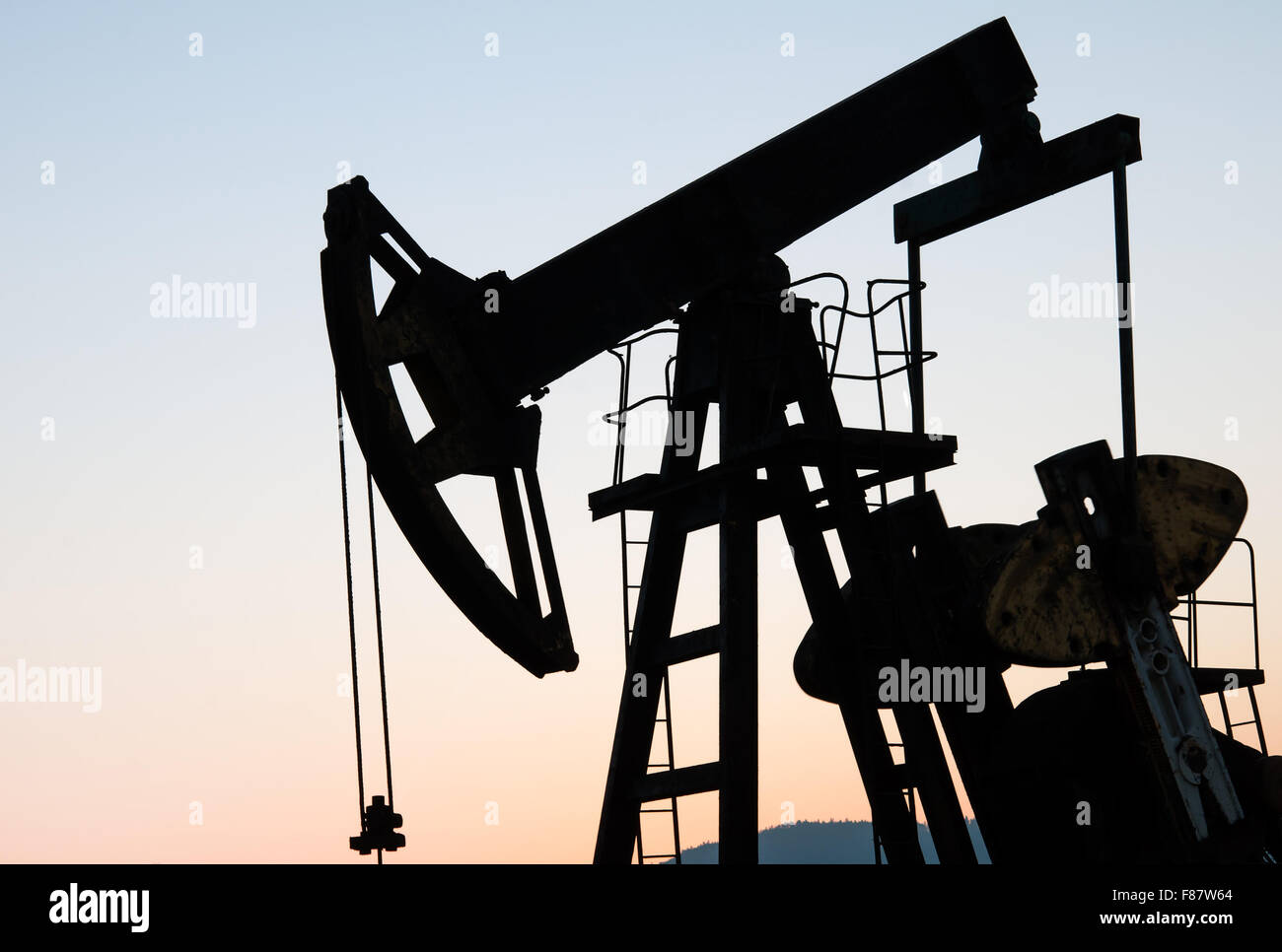operating oil and gas well profiled on sunset sky Stock Photo Alamy
