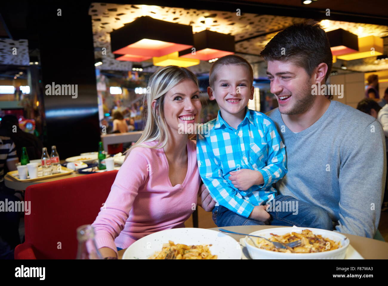 family together have break at lunch in shopping mall Stock Photo