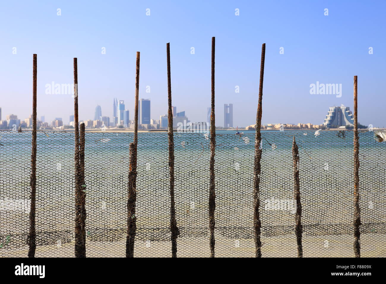 View of Manama, taken from behind fishing nets at Bu Maher Fort, Muharraq,  Kingdom of Bahrain Stock Photo