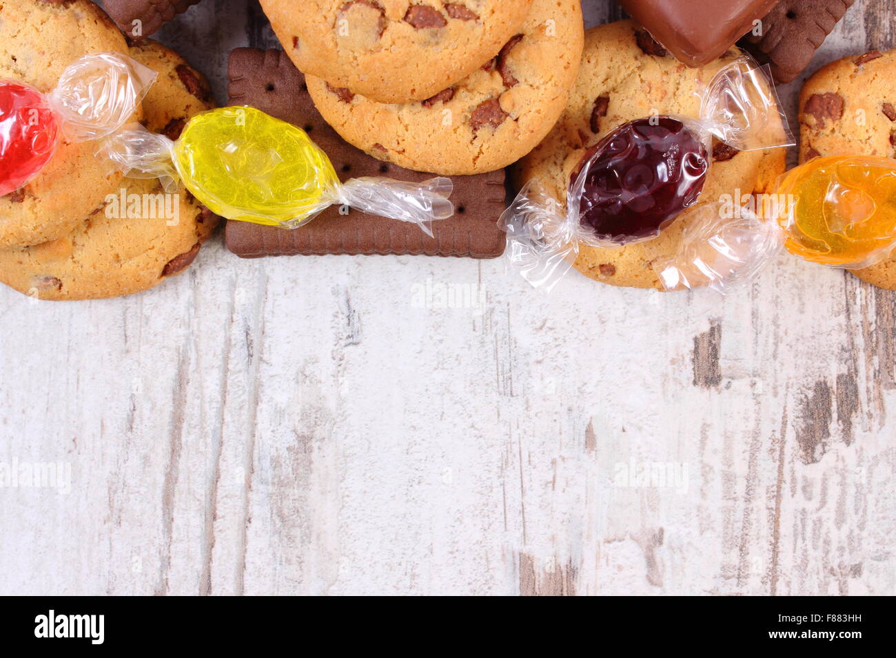 Colorful candies and cookies with copy space for text on old white ...