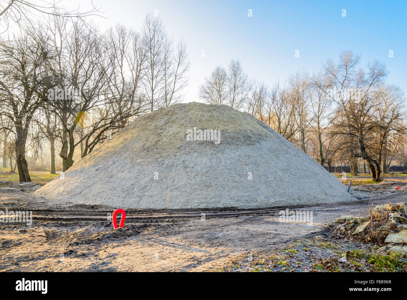 A huge sand pile during construction in the park at sunrise Stock Photo ...