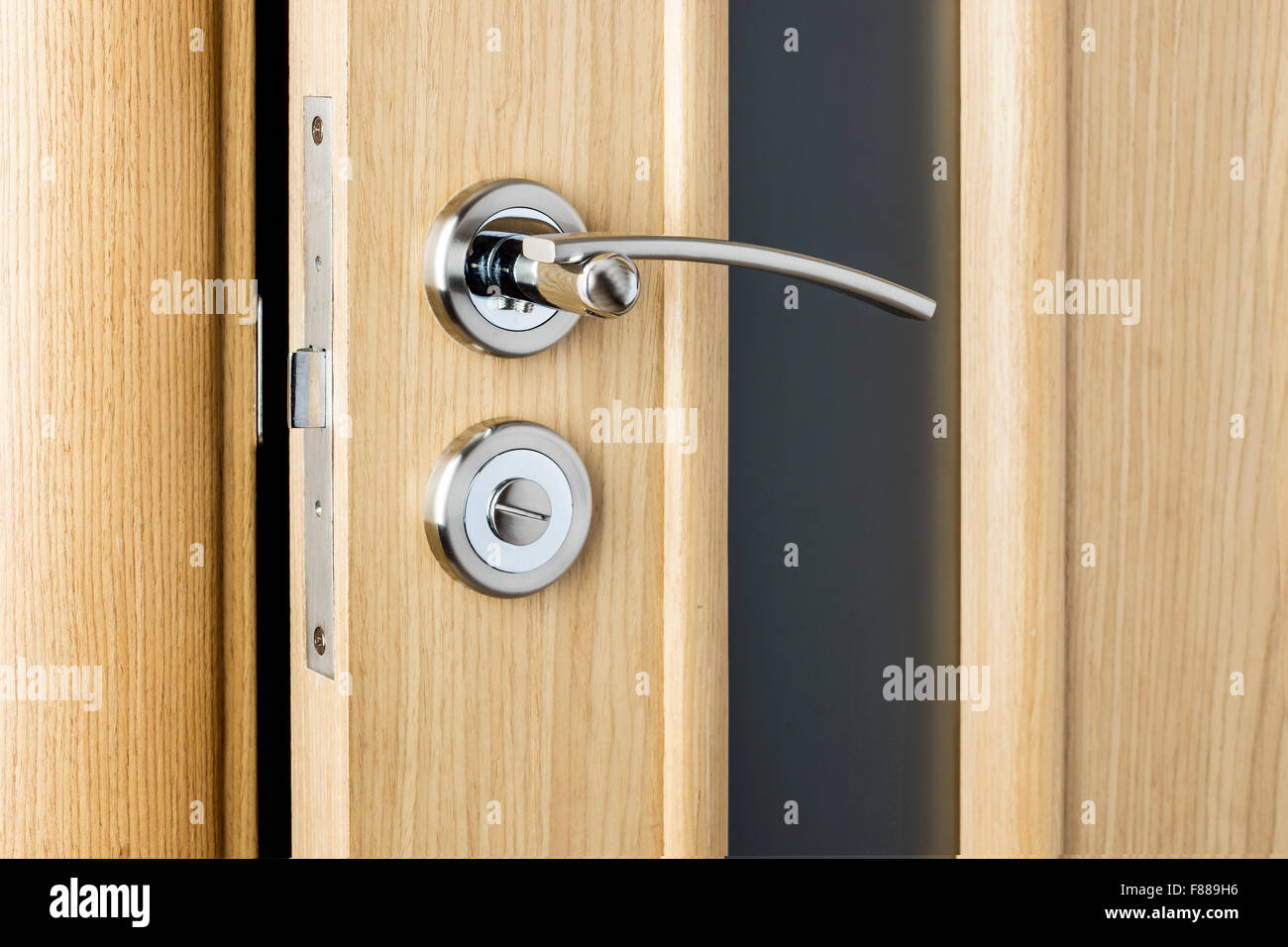 Handle on wooden and glass door close up Stock Photo