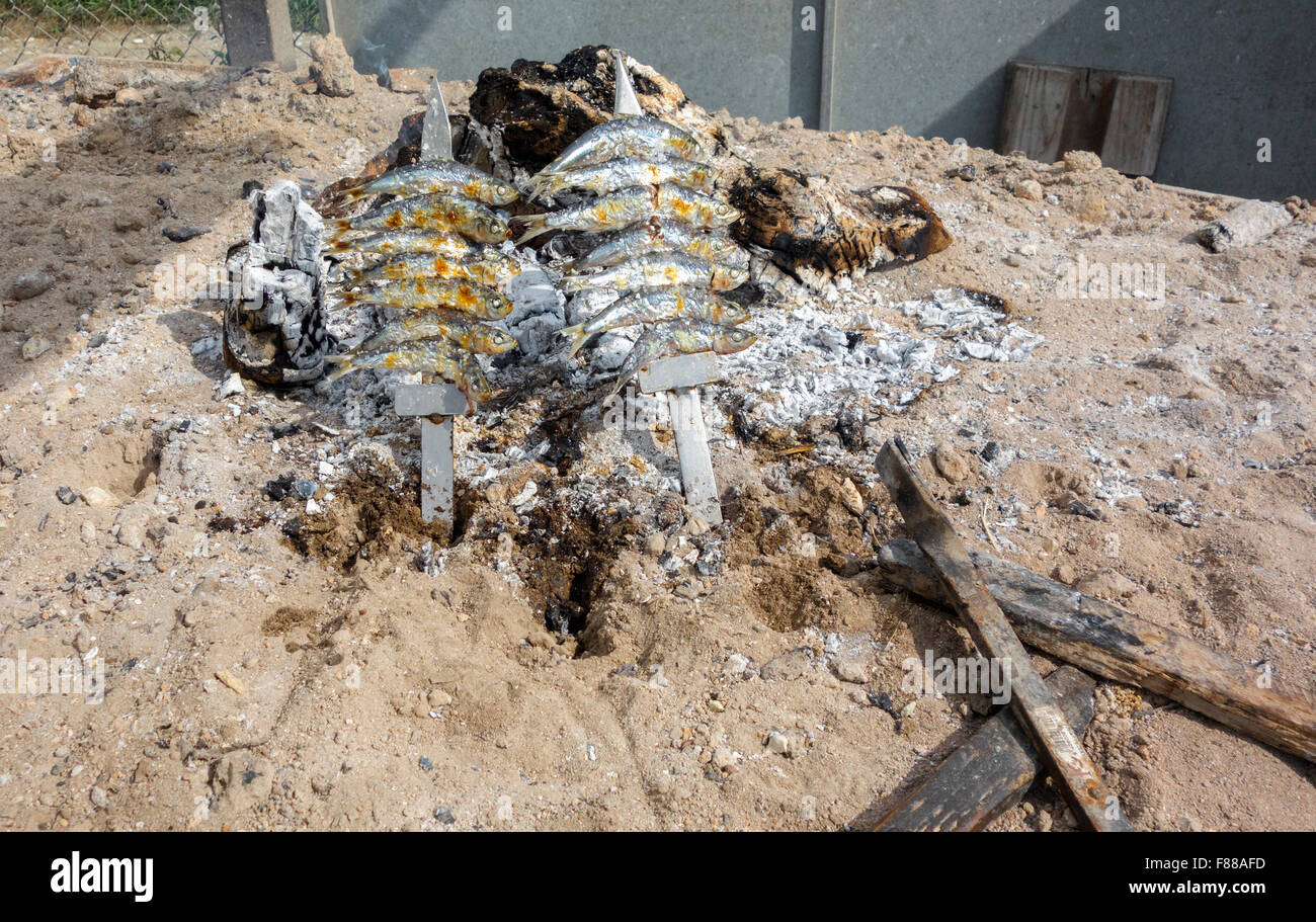 The traditional method of cooking sardines, called sardinas, on the