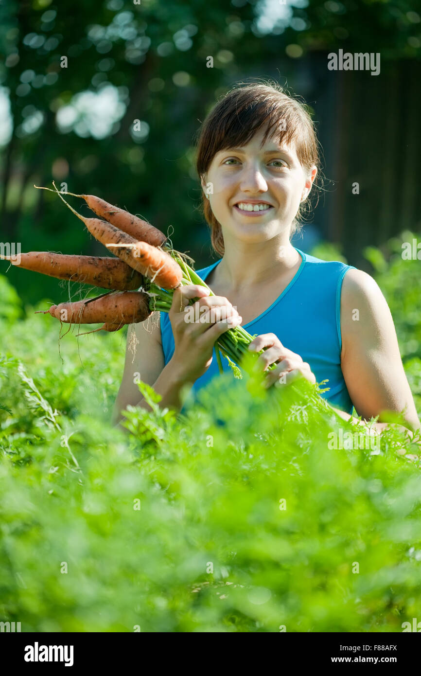 young woman with harvested carrot in field Stock Photo Alamy