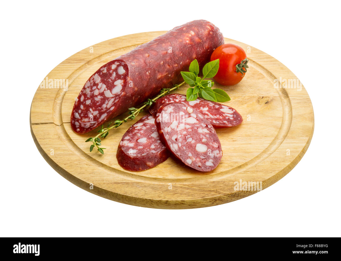 Salami sausages sliced with basil and tomato Stock Photo - Alamy