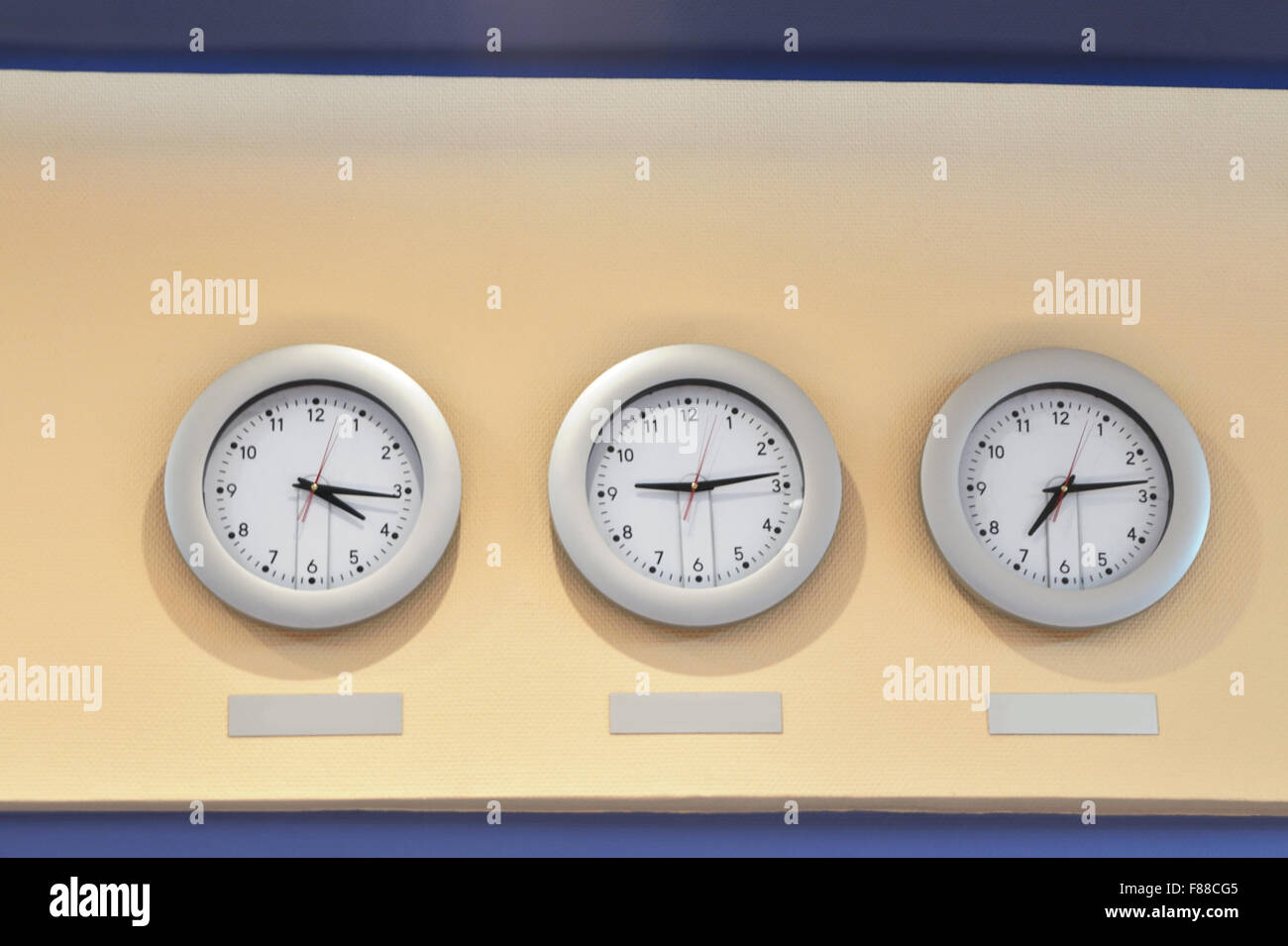 Three clocks on wall hi-res stock photography and images - Alamy