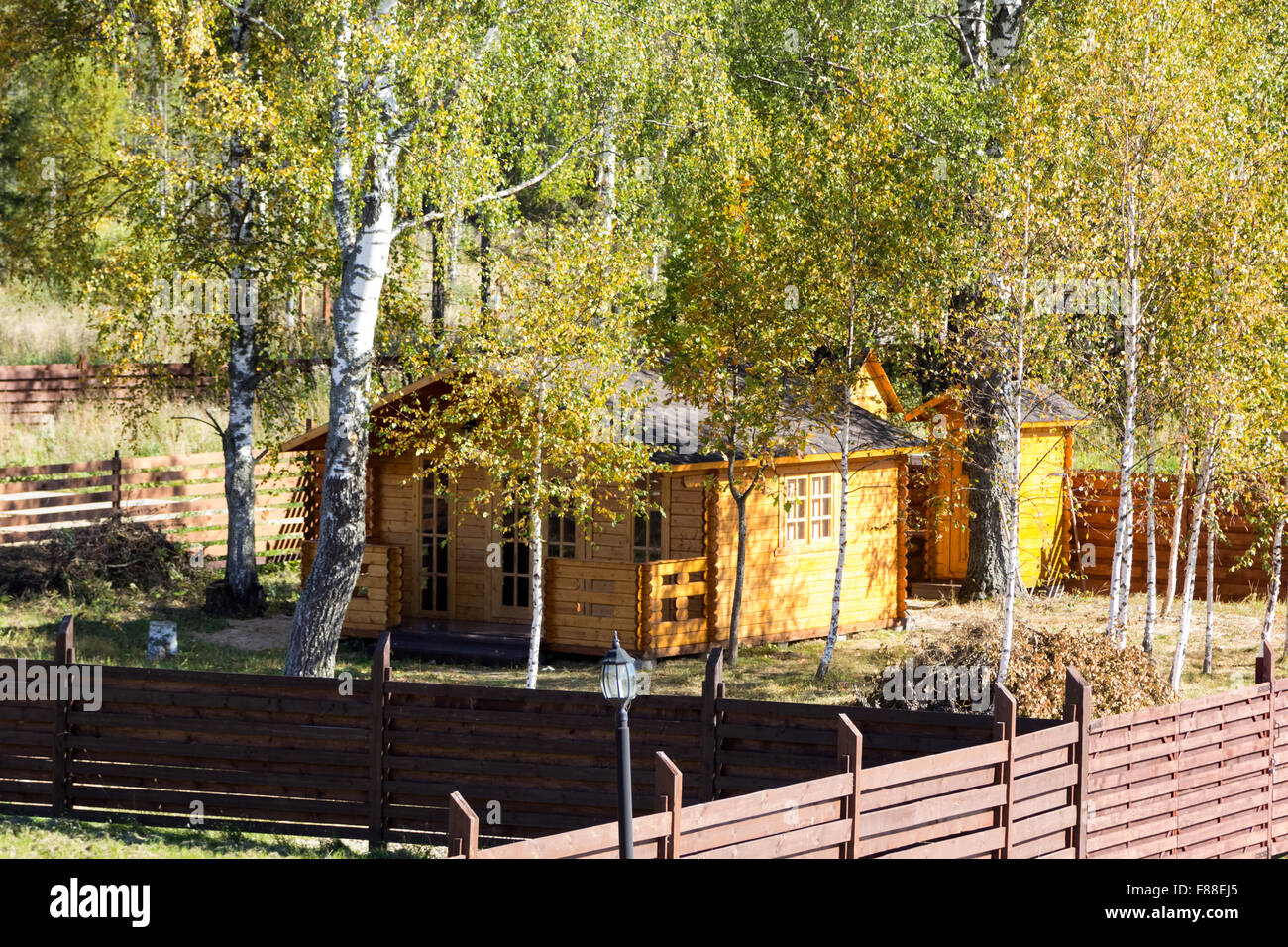 small wooden house among the trees and bushes Stock Photo - Alamy