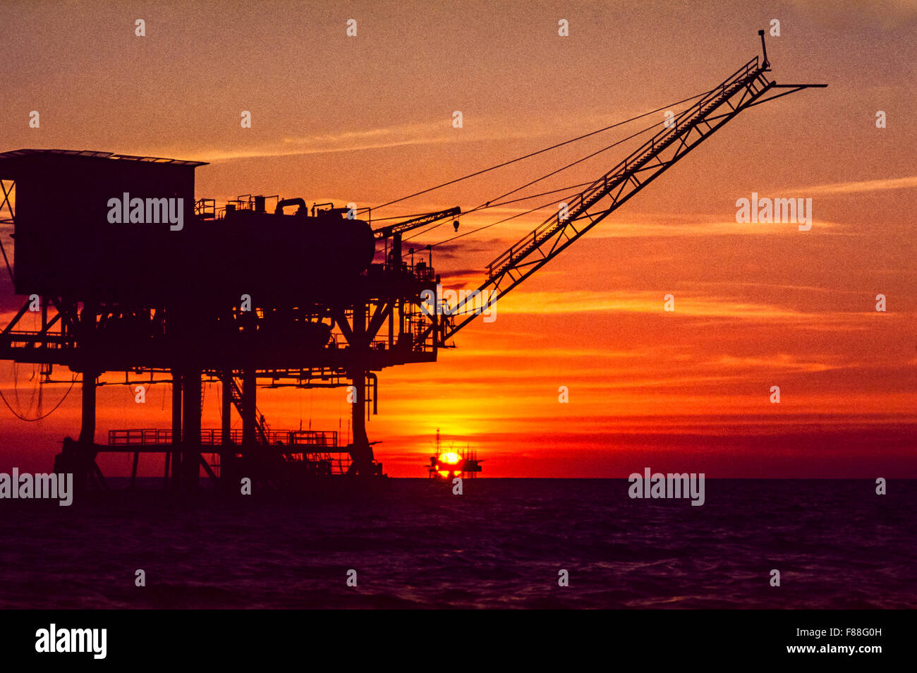 Offshore oil drilling rig with rising sun, Philippines, South East Asia Stock Photo
