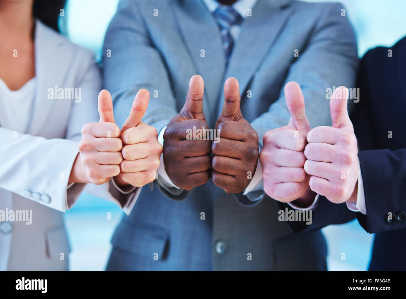 Hands of business people showing thumbs up Stock Photo - Alamy