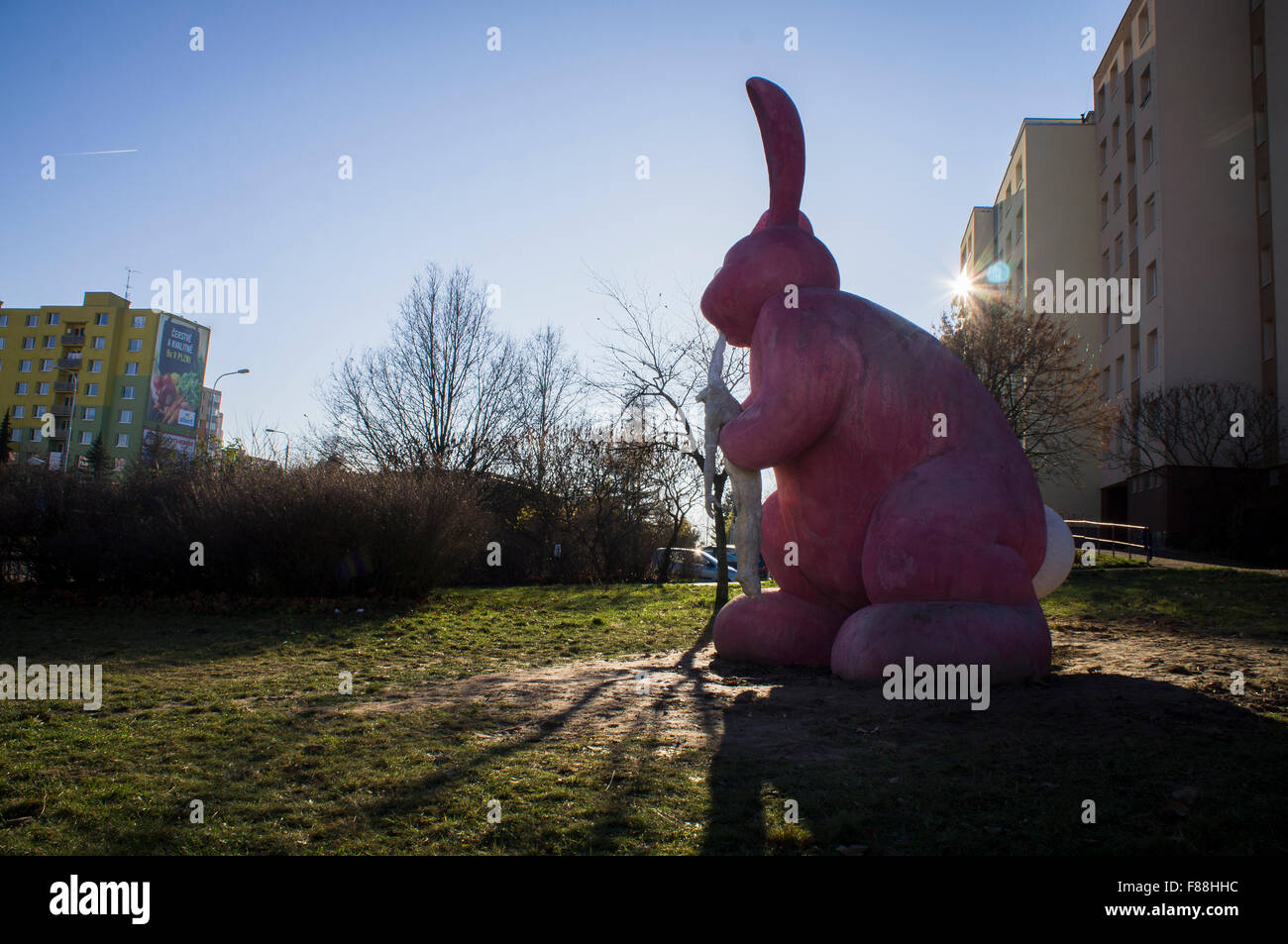 giant pink rabbit eating a headless human body statue Stock Photo