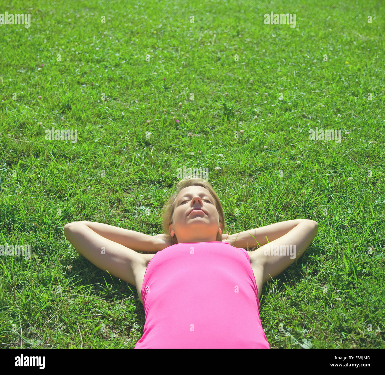 relaxed woman lying on green grass Stock Photo - Alamy