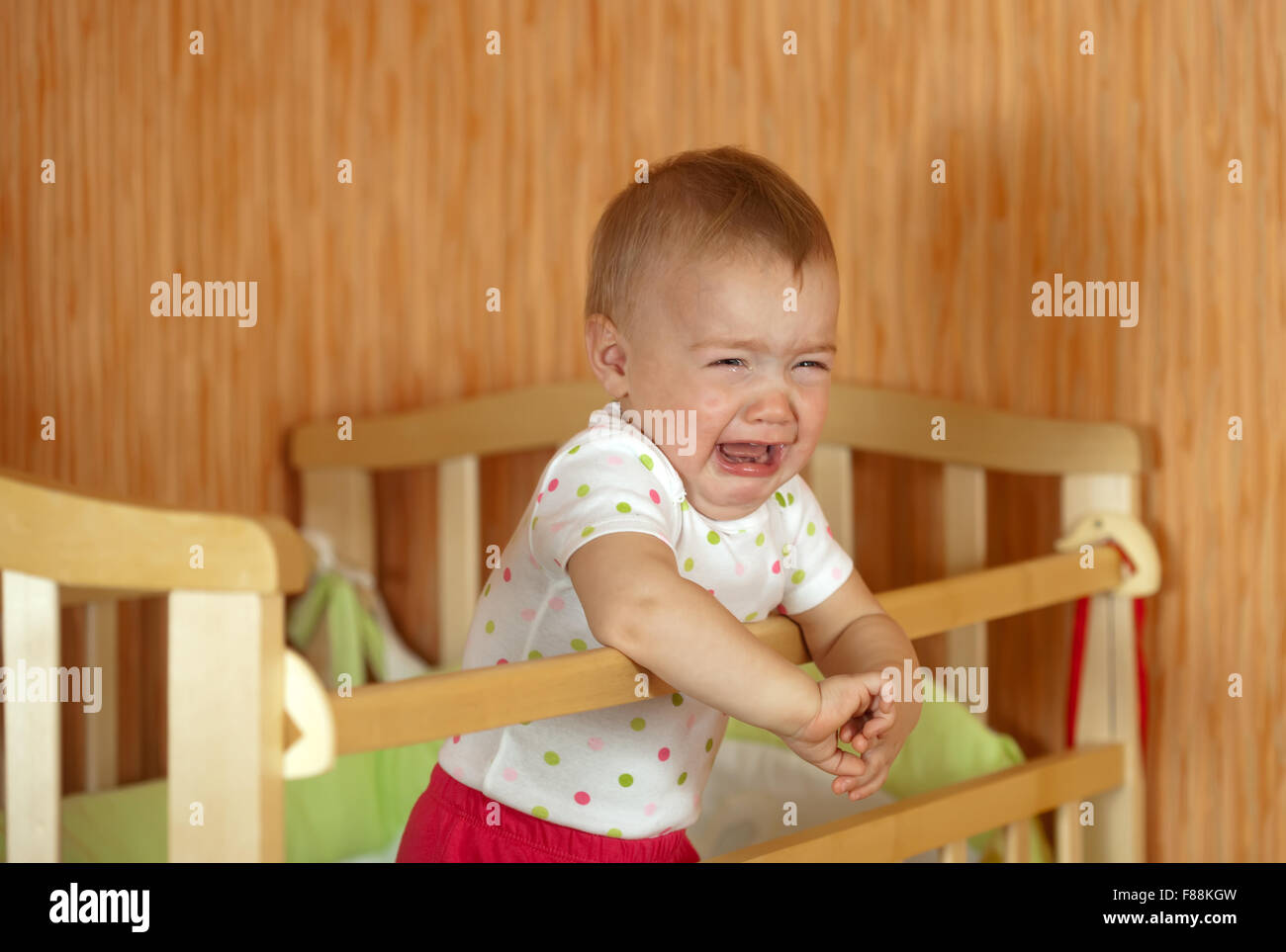 Crying baby of one year old in crib Stock Photo Alamy