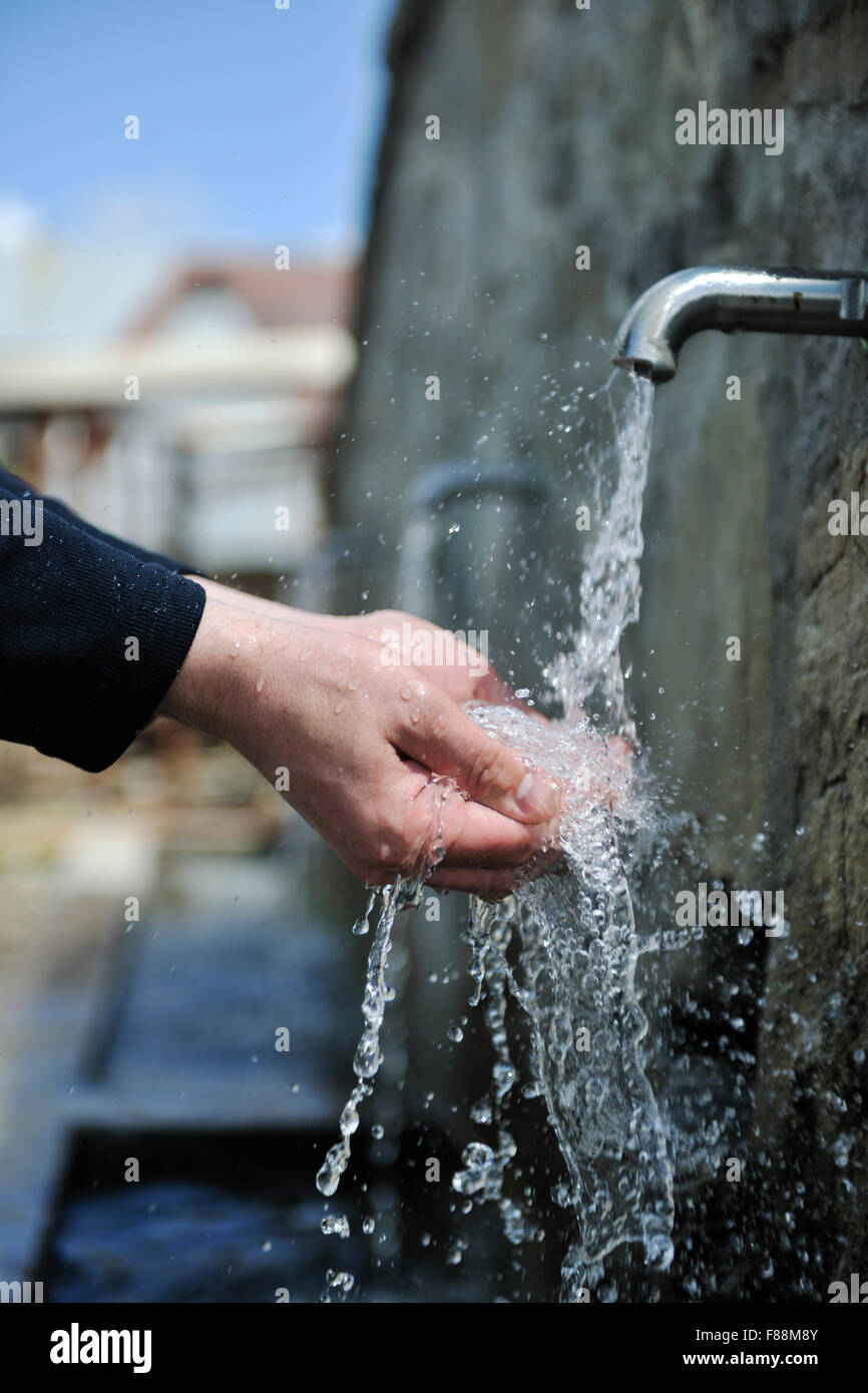clear fresh mountain water falling on hands outdoor in nature Stock ...