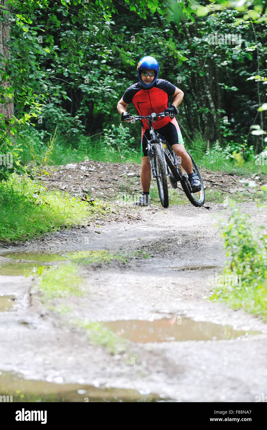 young man drive mountain bike over water river Stock Photo Alamy