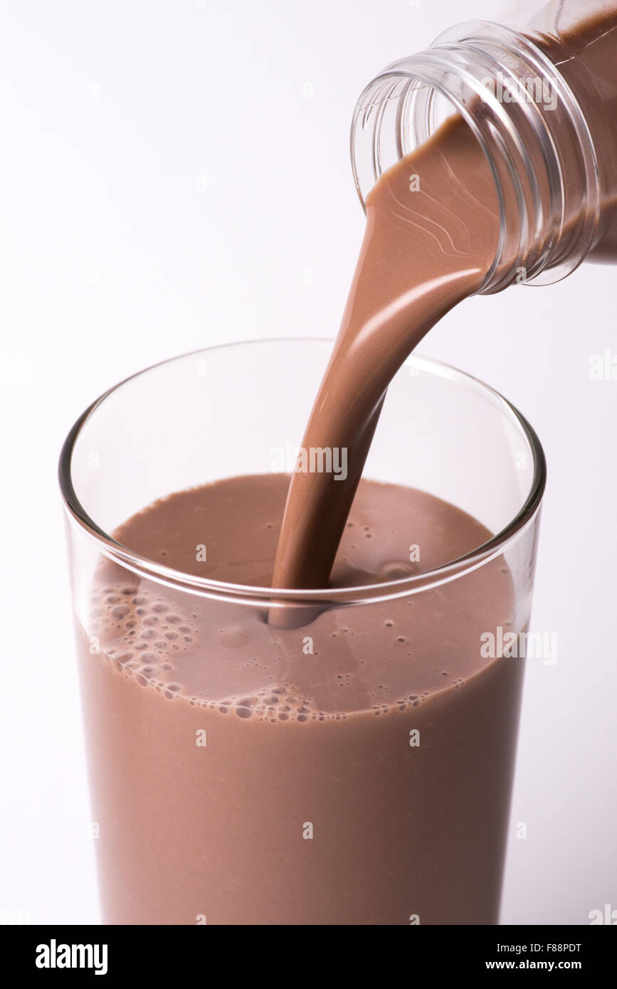 Chocolate milk pouring into a glass Stock Photo - Alamy